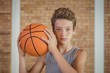 © WavebreakMediaMicro - Determined boy holding a basketball