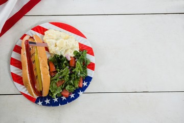 Wall Mural - American flag and hot dog on wooden table