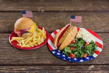 Wall Mural - Burger and hot dog on wooden table with 4th july theme