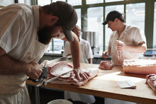 Three Butchers Preparing Meat,cuts Of Meat In Butcher's Shop, Close Up