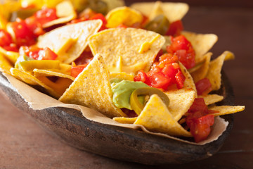 Wall Mural - nachos loaded with salsa, guacamole, cheese and jalapeno