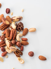 Wall Mural - Background of nuts - pecan, macadamia, brazil nut, walnut, almonds, hazelnuts, pistachios, cashews, peanuts, pine nuts - with copy space. Isolated one edge. Top view or flat lay