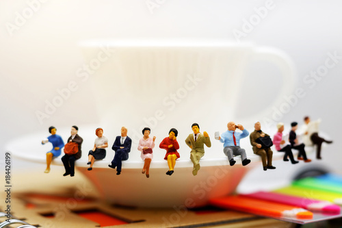 Fotografie, Obraz Miniature people: business team sitting on cup of coffee, break time of business concept