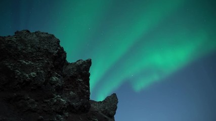 Wall Mural - bright aurora borealis over moonilt rocky volcanic landscpae iceland