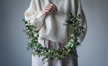 Midsection Of Woman Holding Wreath