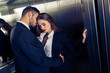 sensual business couple undressing in elevator
