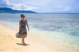 Fototapeta Sport - young relaxed Asian Chinese woman walking on Thailand island beach with amazing beautiful turquoise color water under a summer blue sky