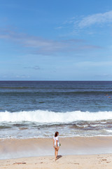 Wall Mural - Beautiful young woman posing on the beach of a tropical island of Bali, Indonesia.