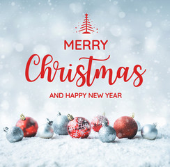 merry christmas and happy new year text with christmas ball (ornament) on snow background.for new ye