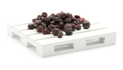 Wall Mural - Freeze dried bilberries on a pallet isolated on white background.