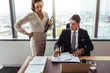 © Jacob Lund - Business people discussing contract documents in office