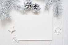 Mockup Christmas Greeting Card With White Tree And Cone, Flatlay On A White Wooden Background, With Place For Your Text