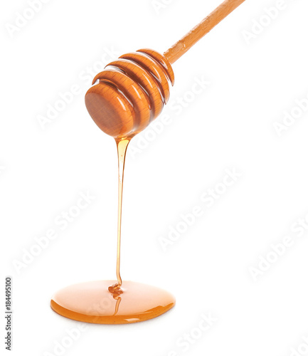 Honey dripping from dipper on white background Tableau sur Toile