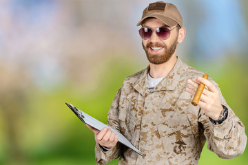 Portrait of young army soldier with a clipboard