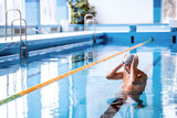 Fototapeta Tęcza - Senior man in an indoor swimming pool.