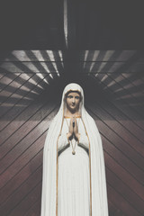 Wall Mural - virgin mary statue. holy woman sculpture in roman catholic church. our lady image