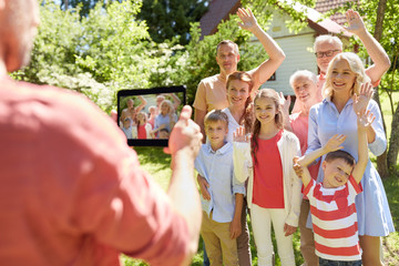 Canvas Print - happy family photographing by tablet pc in summer