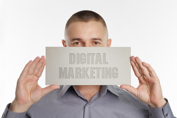 The concept of business, technology, the Internet and the network. Young businessman showing inscription: Digital Marketing