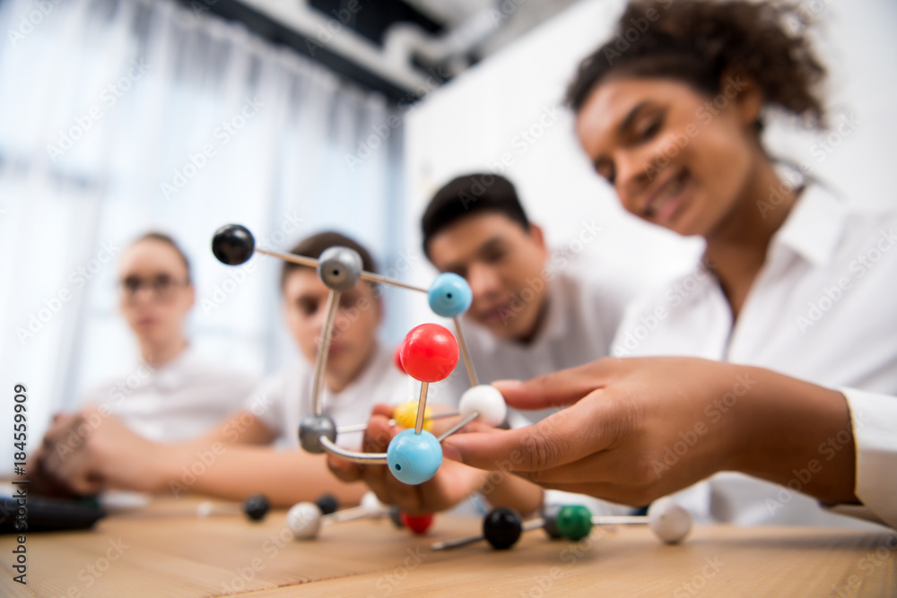 young students picking molecular model for chemistry lesson - obrazy, fototapety, plakaty 