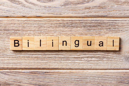 bilingual word written on wood block. bilingual text on table, concept