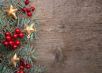 Canvas Print - Fir branch with Christmas decorations on old wooden  background with copy space for text