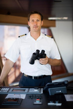 Captain Holding Binoculars In His Hands