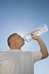  Mature man drinking water from bottle