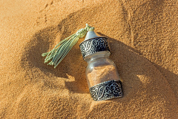 Poster -  souvenir decoration glass jar with golden sand at Sahara desert