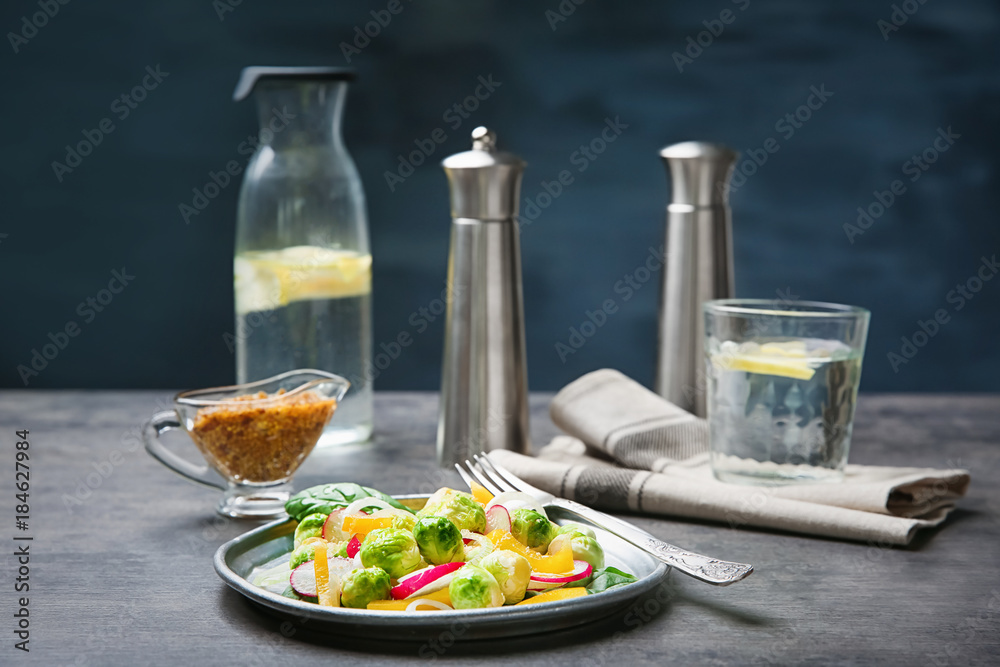 Plate of tasty salad with Brussels sprouts on table