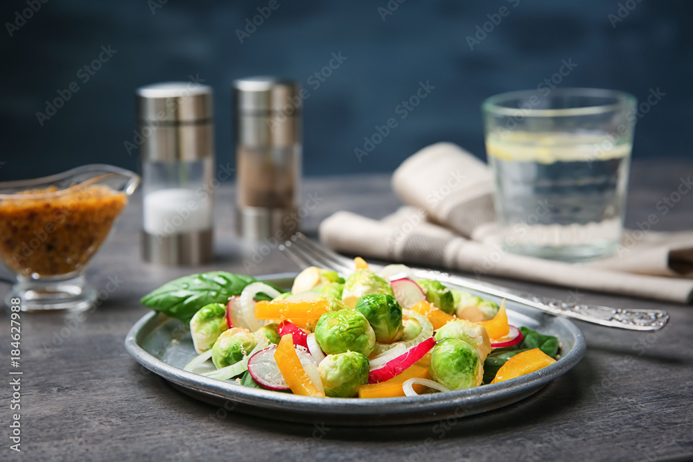 Plate of tasty salad with Brussels sprouts on table