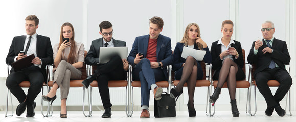 colleagues sitting in the conference room before the meeting