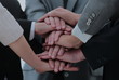 © ASDF - Close up top view of business people putting their hands togethe