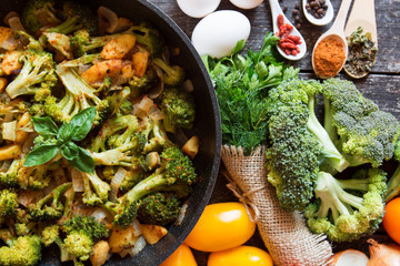 fresh broccoli and orange tomatoes, cooked broccoli with mushrooms, carrots and potatoes. organic and vegan food kitchen 