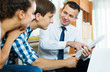 © JackF - Spouses and salesman with documents