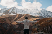 Man Standing In Mountains With His Arms Outstretched, Georgia