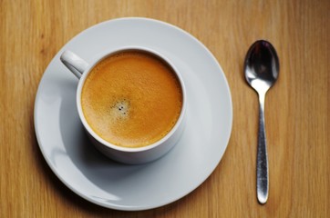 Cup of coffee espresso hot drinks for breakfast in the morning or afternoon break time ready on a wooden background.