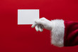 © ink drop - Santa Claus hand holding a blank white sign