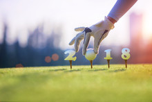 Concept Of Golf Ball Invitation Incomming Year 2018, On The Tee Off Prepare By Hand Of Woman In The Golf Course