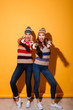 © Drobot Dean - Full length portrait of two cheery girls
