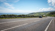 Scottish Highland road trip. A quiet coastal road running through the Highlands of Scotland on a bright summers day.