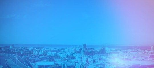 Poster - Cityscape by sea against blue sky