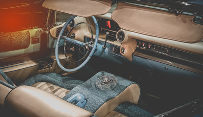 Wall Mural - Interior of luxury old vintage car close up. View of dashboard and interior of old vintage with sunlight effect for background.