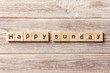 Happy sunday word written on wood block. Happy sunday text on table, concept