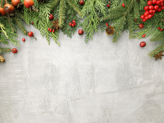 christmas background with fir branches, pine cones and red berries. floral new year frame. winter bo