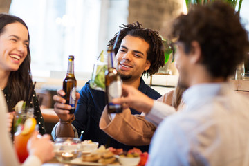 Canvas Print - happy friends drinking non alcoholic beer at bar