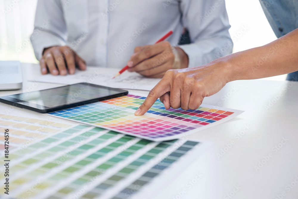 Two young interior design or graphic designer working on project of ...