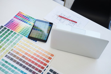 Poster - Creative creativity graphic designer working with graphics tablet,laptop and smart phone, colour chart at workplace on wooden desk , colour ideas style concept