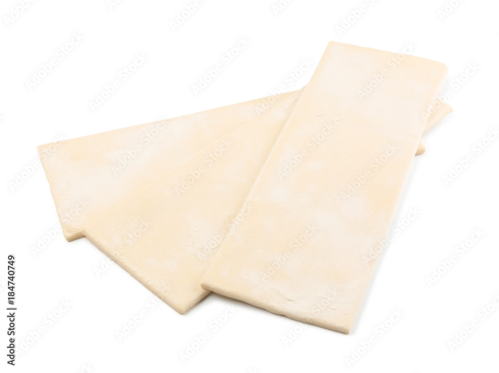 Raw puff pastry on white background