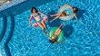 © Iuliia Sokolovska - Aerial top view of family in swimming pool from above, happy mother and kids swim on inflatable ring donuts and have fun in water on family vacation