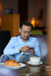 © DragonImages - Checking smartphone